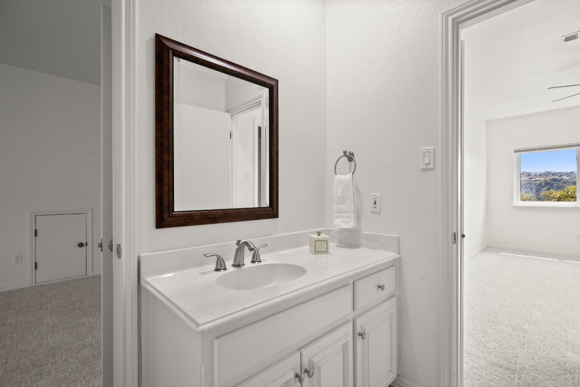 4906 Bob Cat Run Austin, TX 78731 - Photo 17 of 37 Bathroom with vanity and baseboards