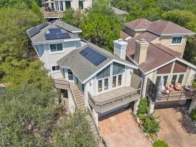 an aerial view of a house with a yard