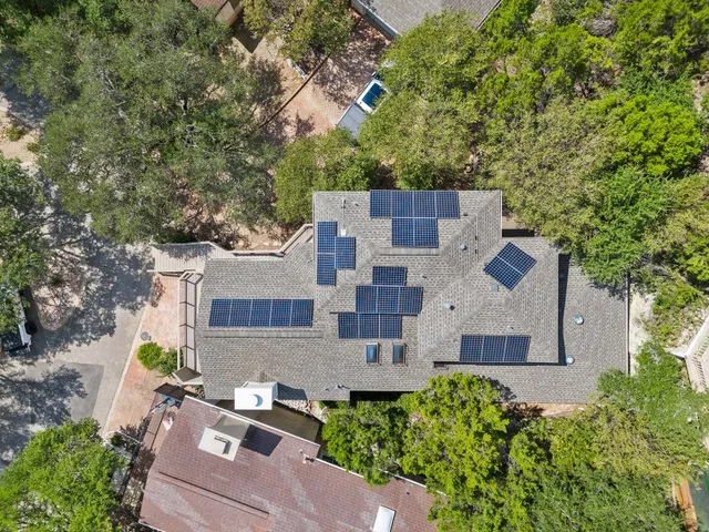 an aerial view of a house with a yard