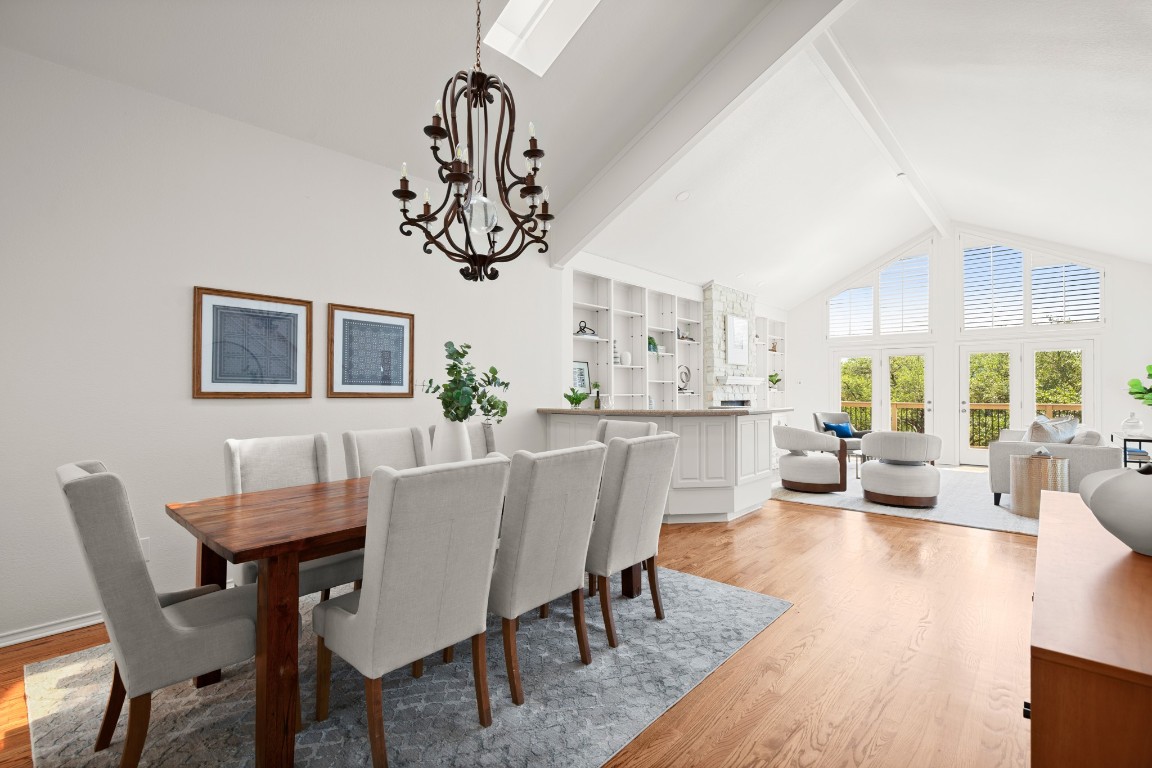 4906 Bob Cat Run Austin, TX 78731 - Photo 4 of 37 Dining room with beamed ceiling, high vaulted ceiling, light wood-style flooring, and a chandelier