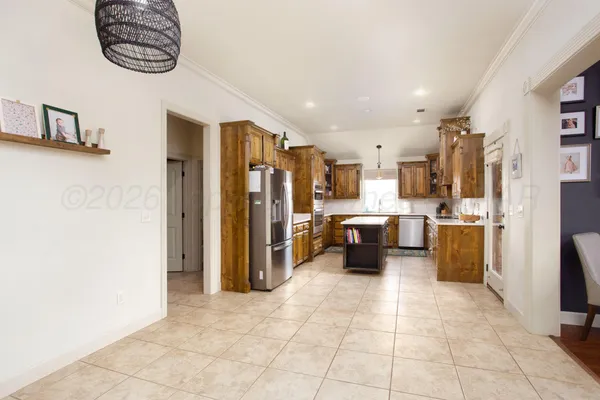 a kitchen with stainless steel appliances a refrigerator and a stove top oven