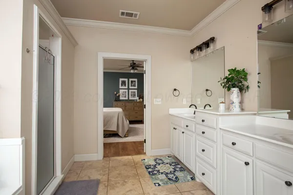 a spacious bathroom with a sink and a mirror