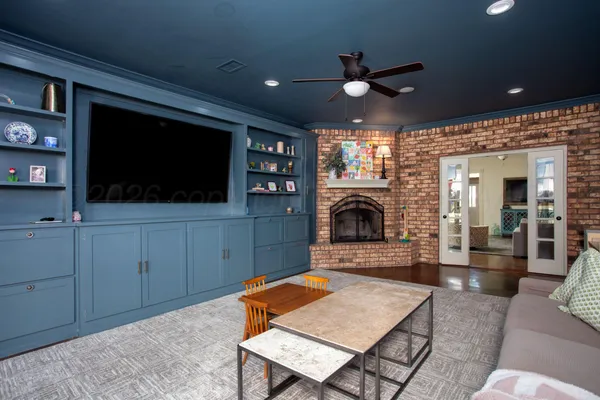 a living room with furniture a flat screen tv and a fireplace