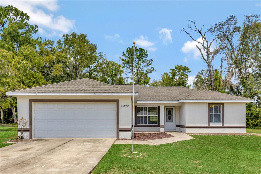 6292 Hemlock Road Ocala, FL 34472 - Photo 1 of 1 front view of a house with a yard and trees