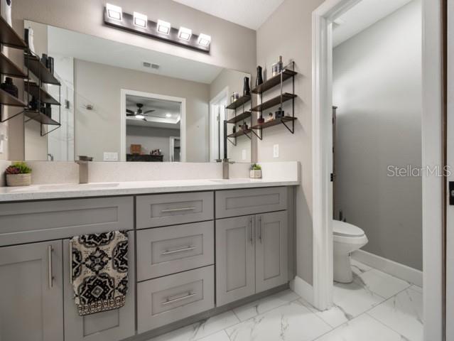 156 Juniper Circle Ocala, FL 34480 - Photo 14 of 40 a bathroom with a granite countertop sink toilet and mirror