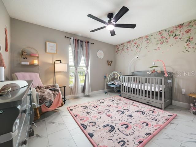 156 Juniper Circle Ocala, FL 34480 - Photo 15 of 40 a bedroom with furniture and baby bed