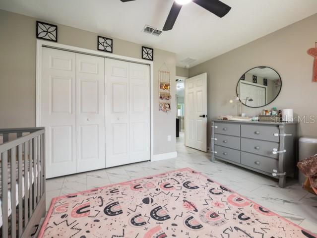 156 Juniper Circle Ocala, FL 34480 - Photo 16 of 40 a spacious bedroom with a bed and a dresser