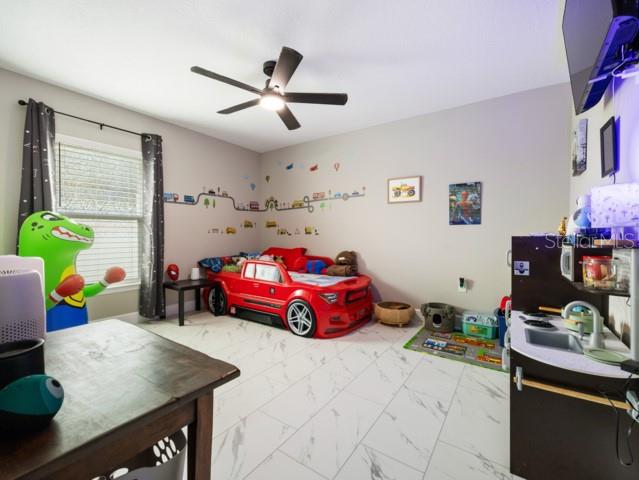 156 Juniper Circle Ocala, FL 34480 - Photo 18 of 40 a kids room with furniture and a window