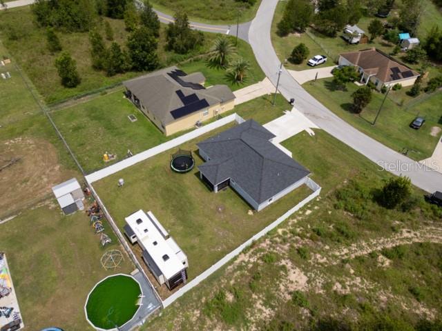 156 Juniper Circle Ocala, FL 34480 - Photo 29 of 40 an aerial view of a pool a yard lawn chairs and yard