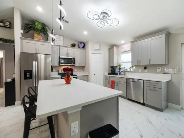 a kitchen with a refrigerator and a sink