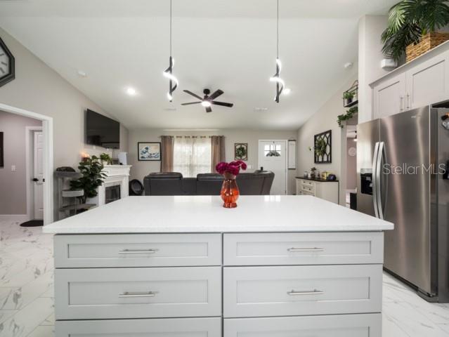 156 Juniper Circle Ocala, FL 34480 - Photo 9 of 40 a large kitchen with stainless steel appliances kitchen island a refrigerator and a stove