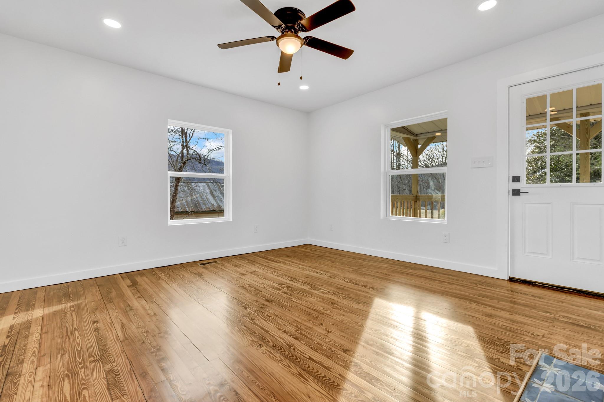 246 Marion Street Marion, NC 28752 - Photo 16 of 48 a view of an empty room with window and wooden floor