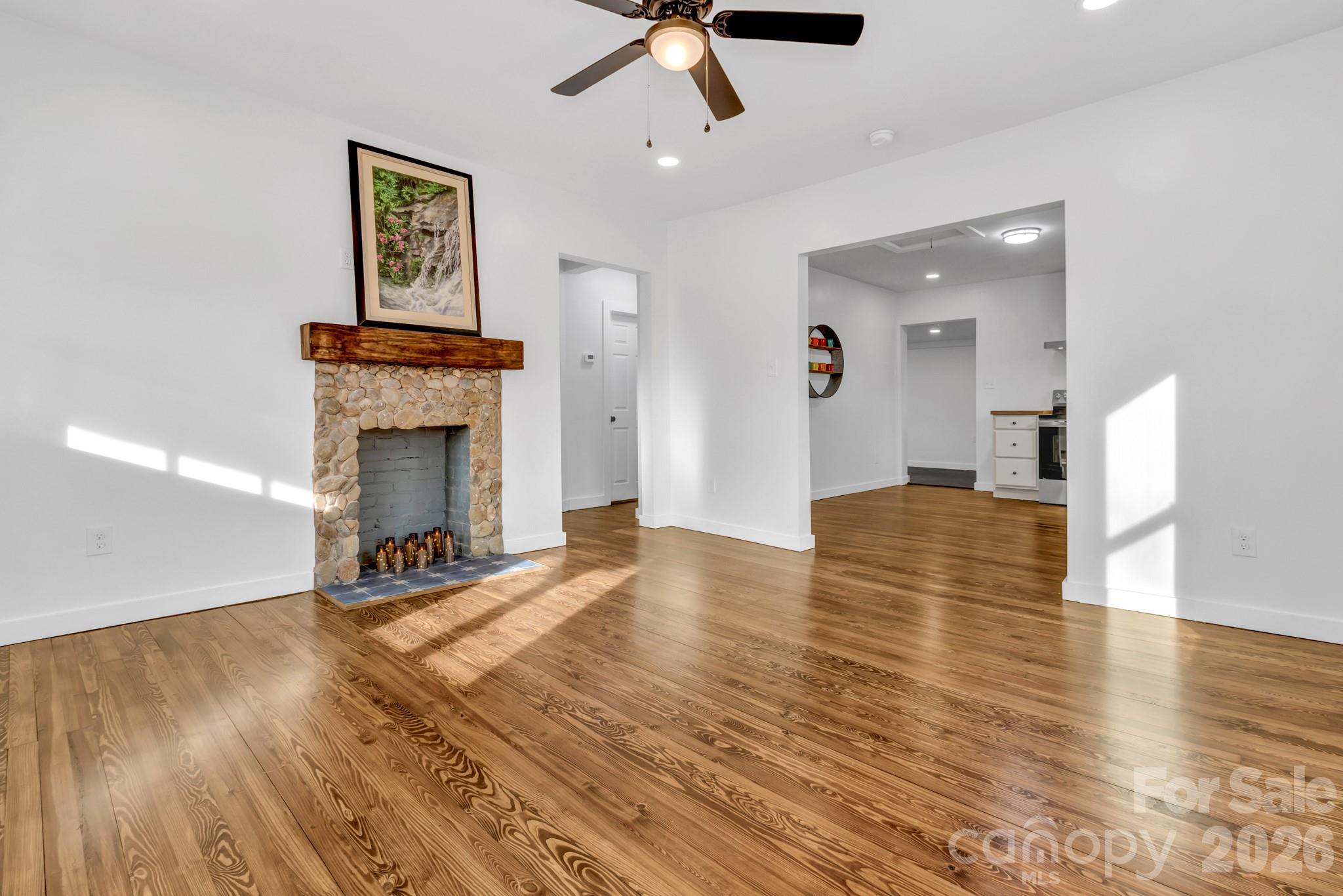 246 Marion Street Marion, NC 28752 - Photo 18 of 48 a view of empty room with wooden floor and fireplace