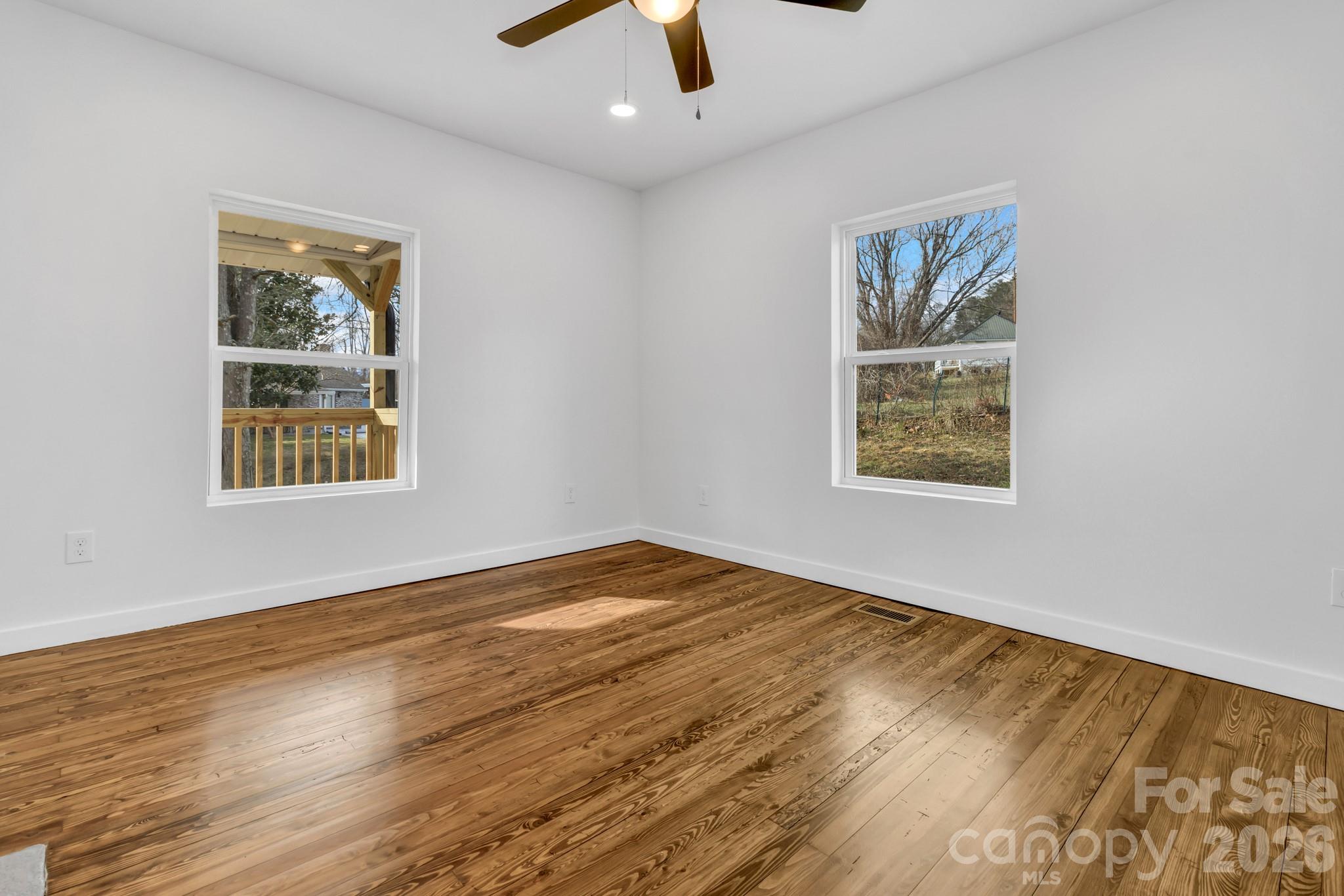 246 Marion Street Marion, NC 28752 - Photo 20 of 48 a view of an empty room with window and wooden floor