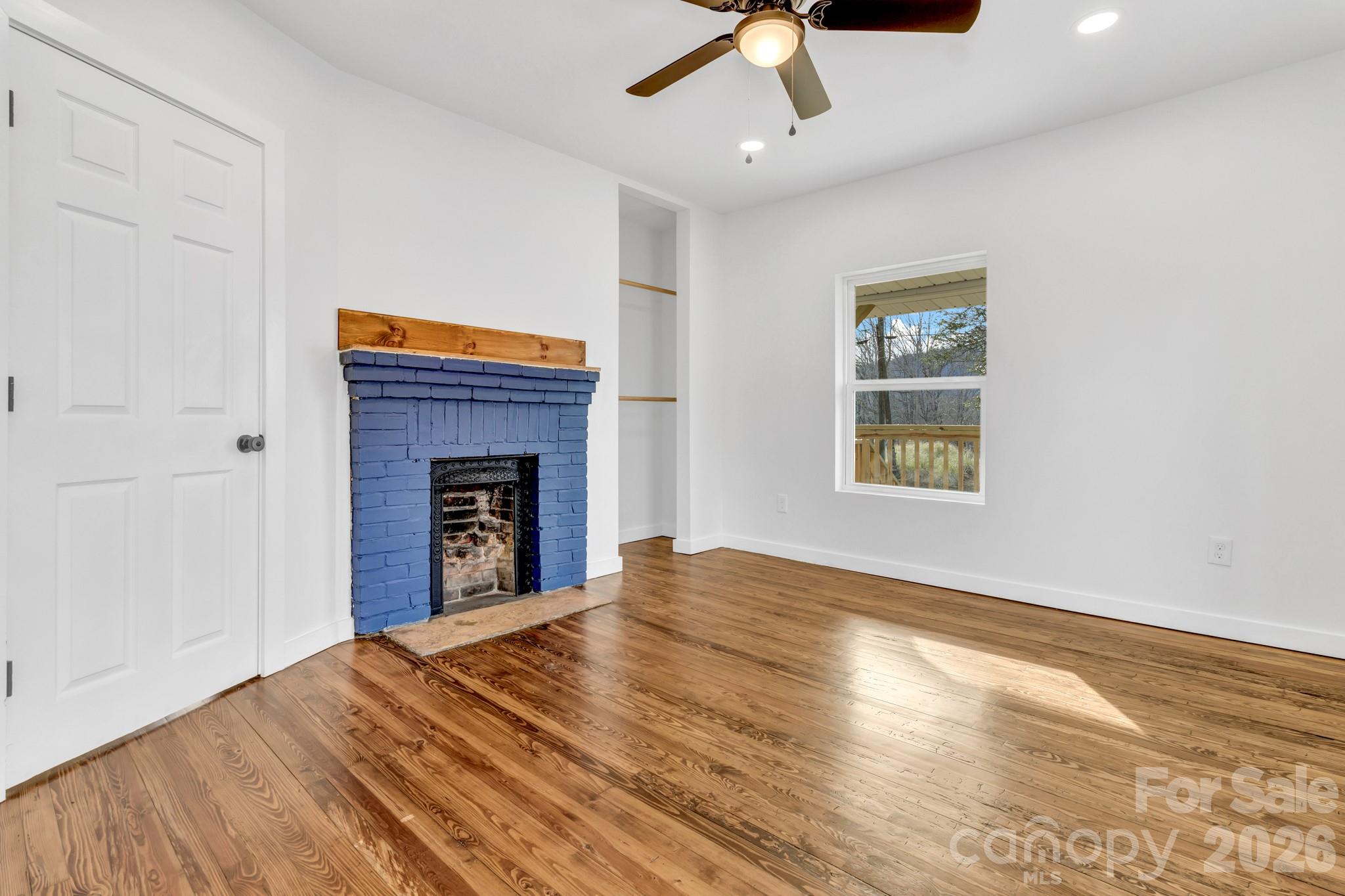 246 Marion Street Marion, NC 28752 - Photo 22 of 48 an empty room with ceiling fan and window