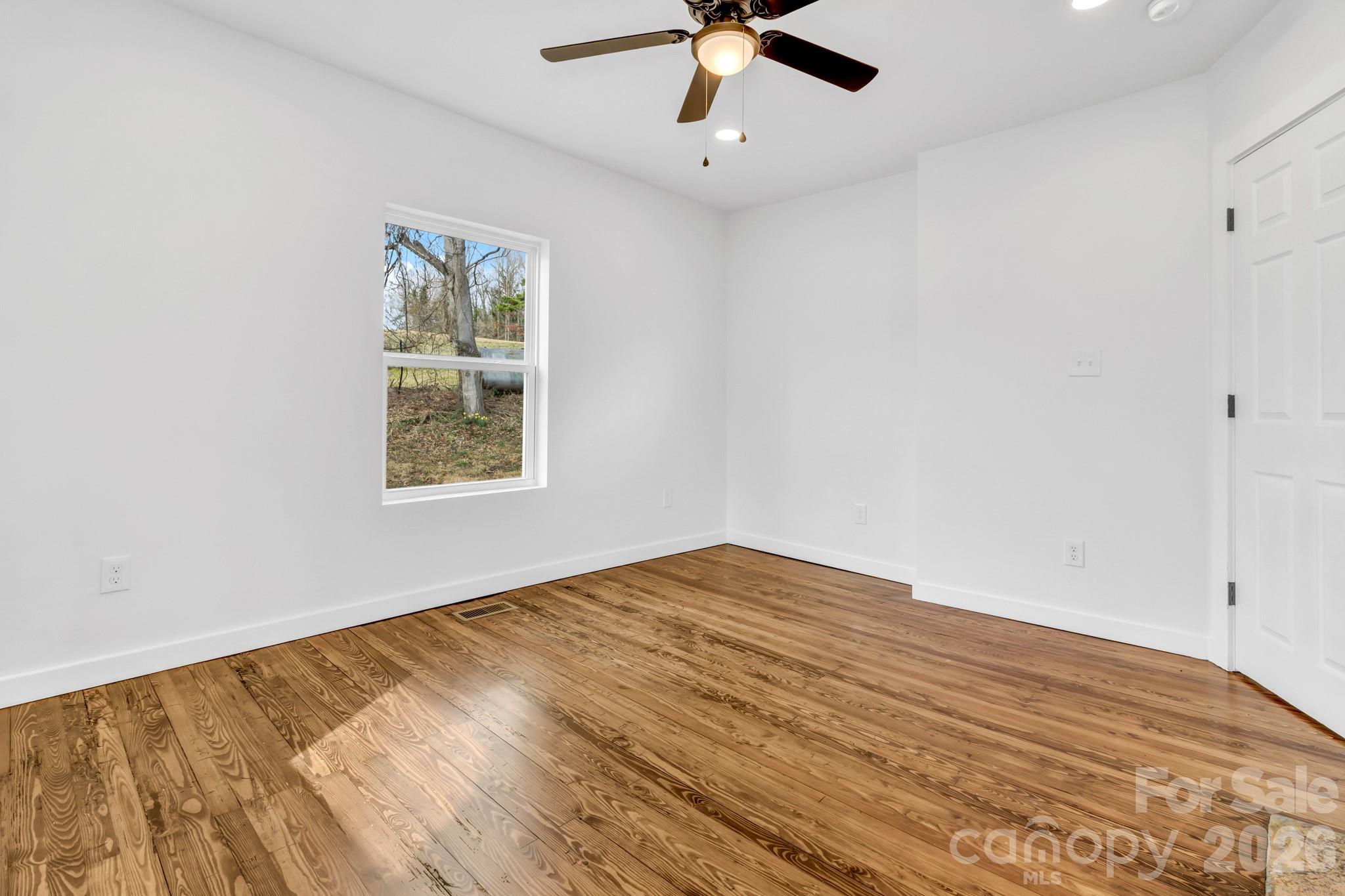 246 Marion Street Marion, NC 28752 - Photo 23 of 48 a view of empty room with wooden floor