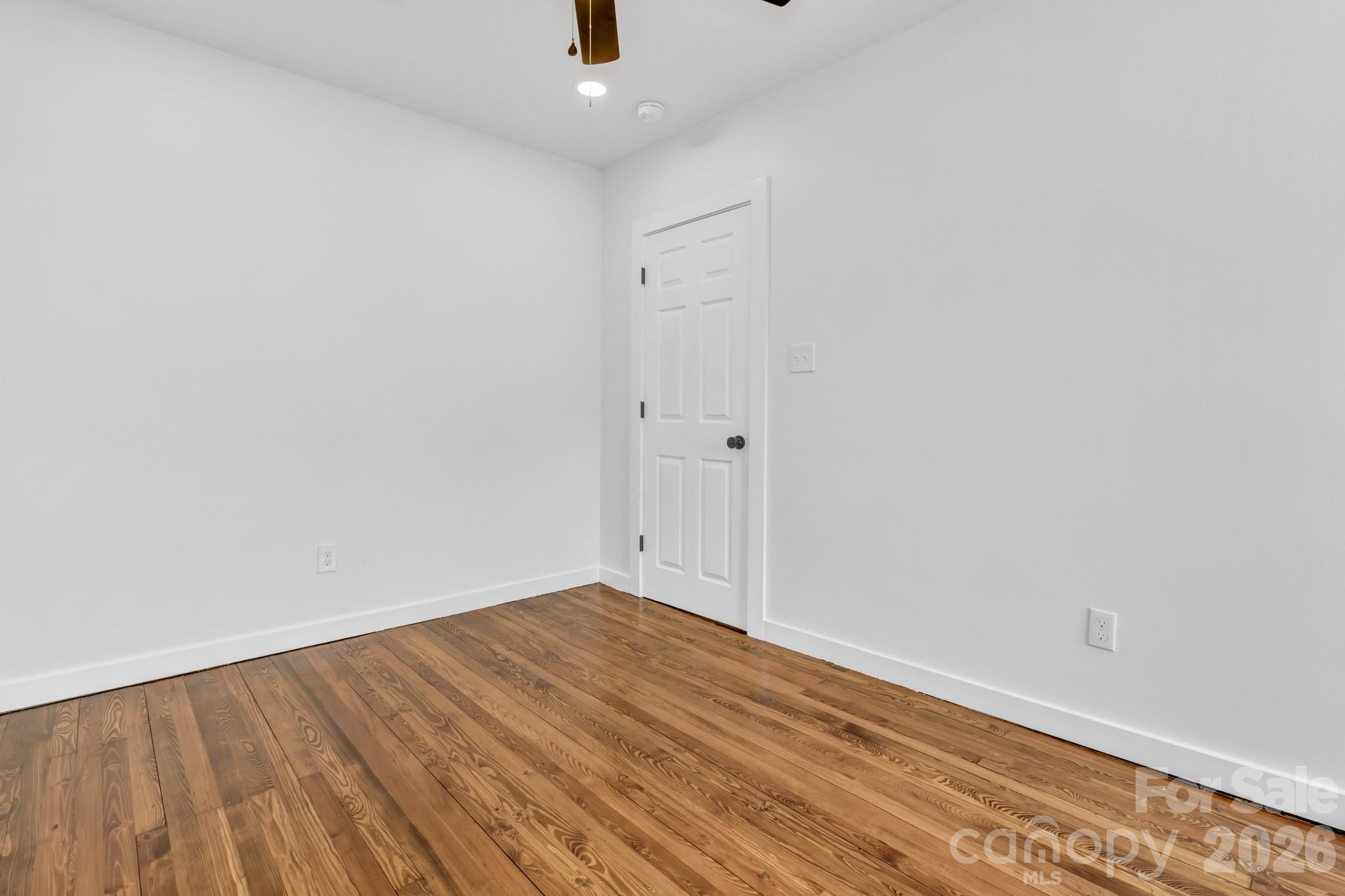 246 Marion Street Marion, NC 28752 - Photo 25 of 48 a view of an empty room with wooden floor