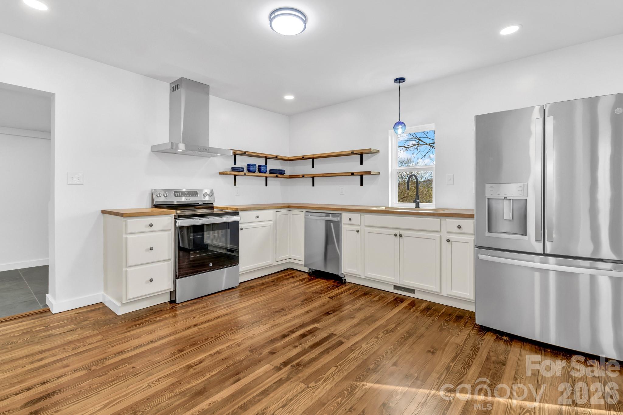 246 Marion Street Marion, NC 28752 - Photo 29 of 48 a kitchen with white cabinets stainless steel appliances and sink