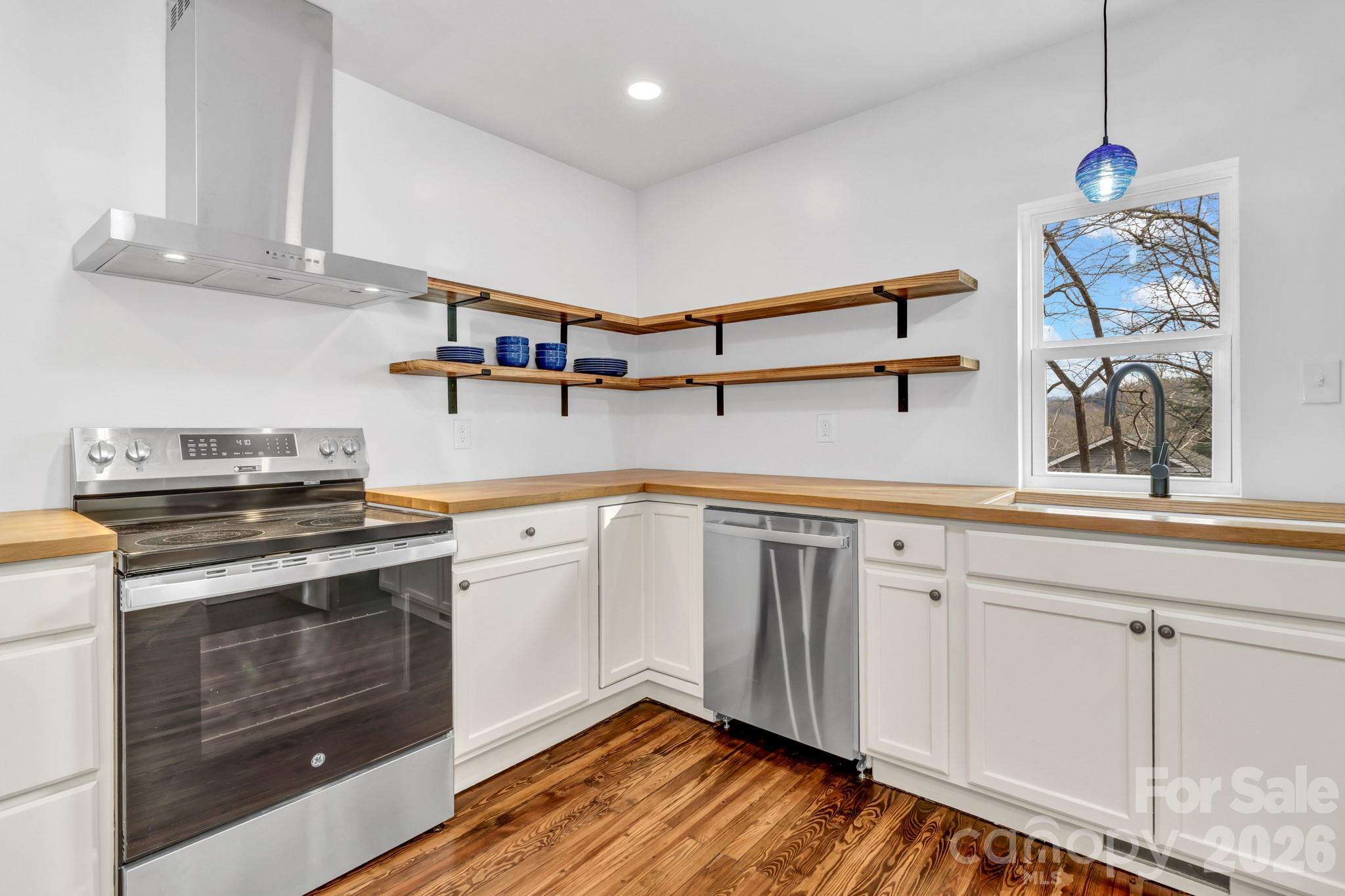 246 Marion Street Marion, NC 28752 - Photo 32 of 48 a kitchen with stainless steel appliances granite countertop a sink and a stove