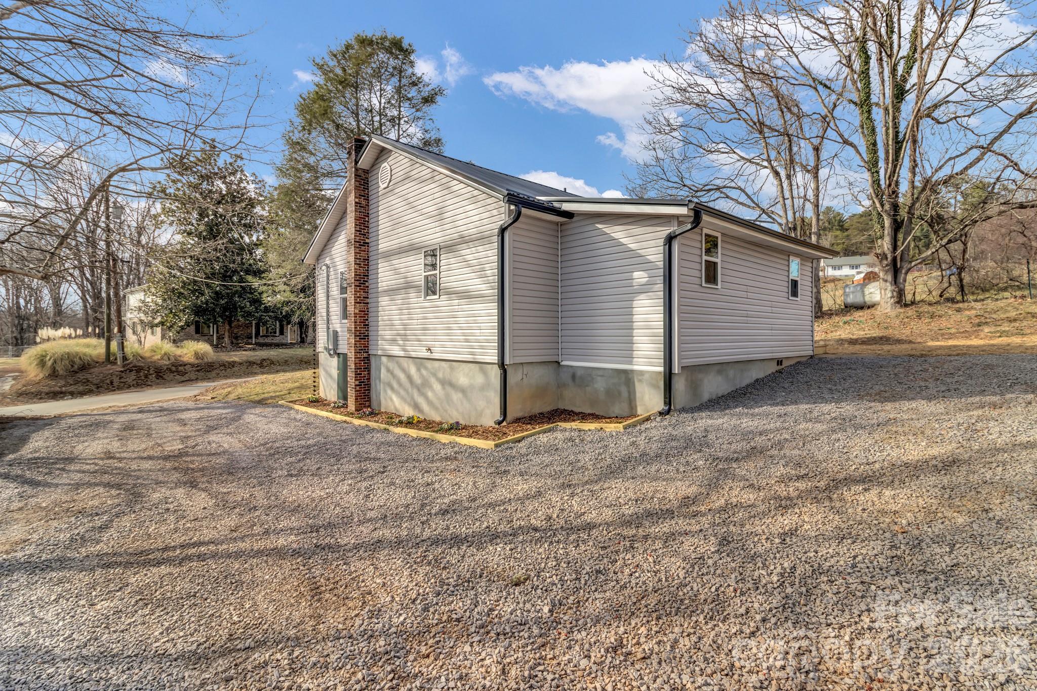 246 Marion Street Marion, NC 28752 - Photo 47 of 48 a view of a house with a yard and garage