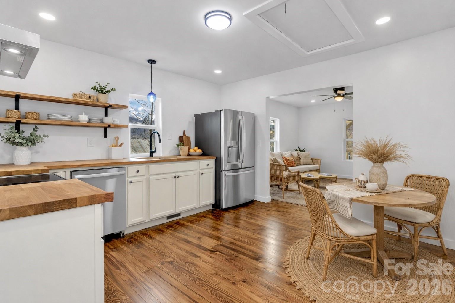 246 Marion Street Marion, NC 28752 - Photo 5 of 48 a kitchen with a sink a refrigerator and chairs