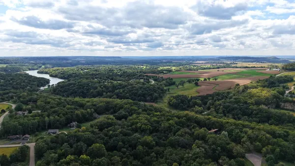 a view of a city with lush green forest