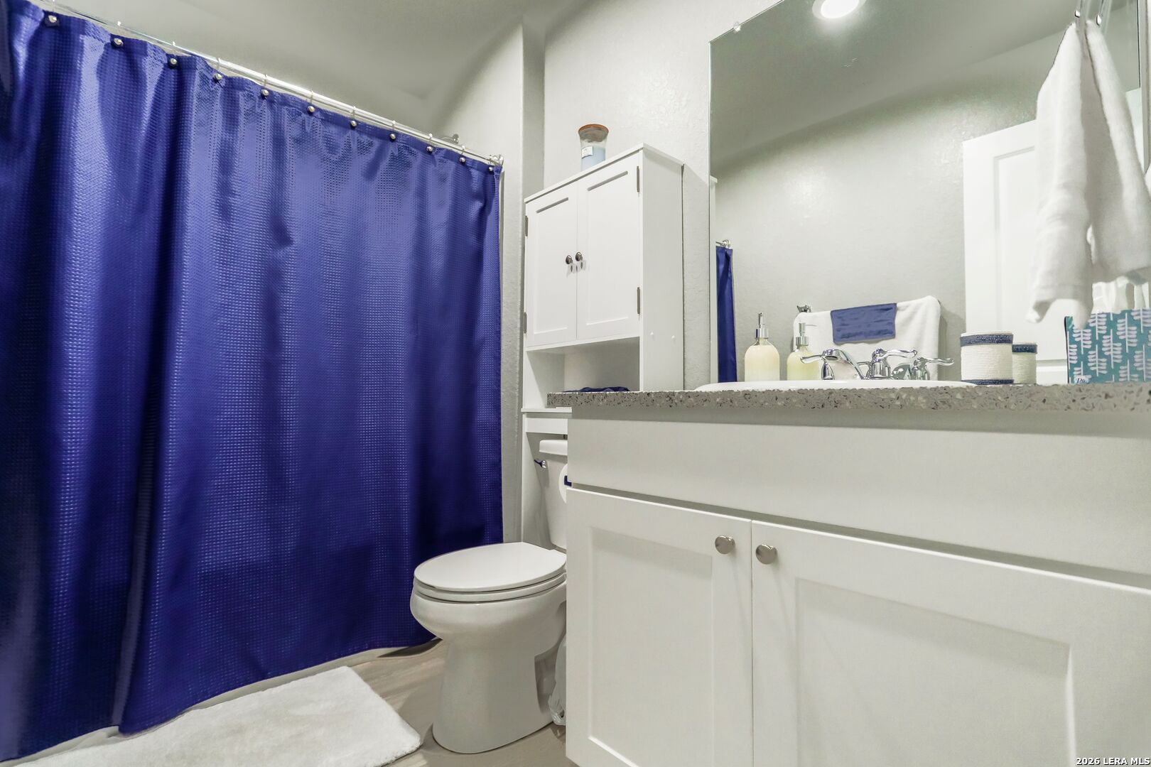 3318 Carducci Drive Converse, TX 78109 - Photo 13 of 14 a bathroom with a toilet a sink and a mirror