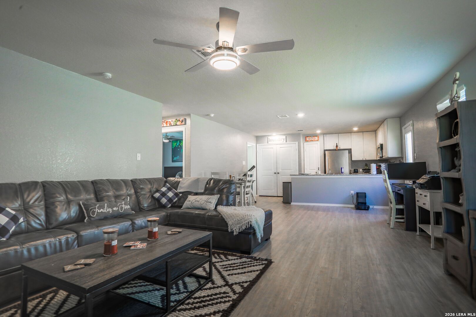 3318 Carducci Drive Converse, TX 78109 - Photo 5 of 14 a living room with furniture kitchen view and a wooden floor