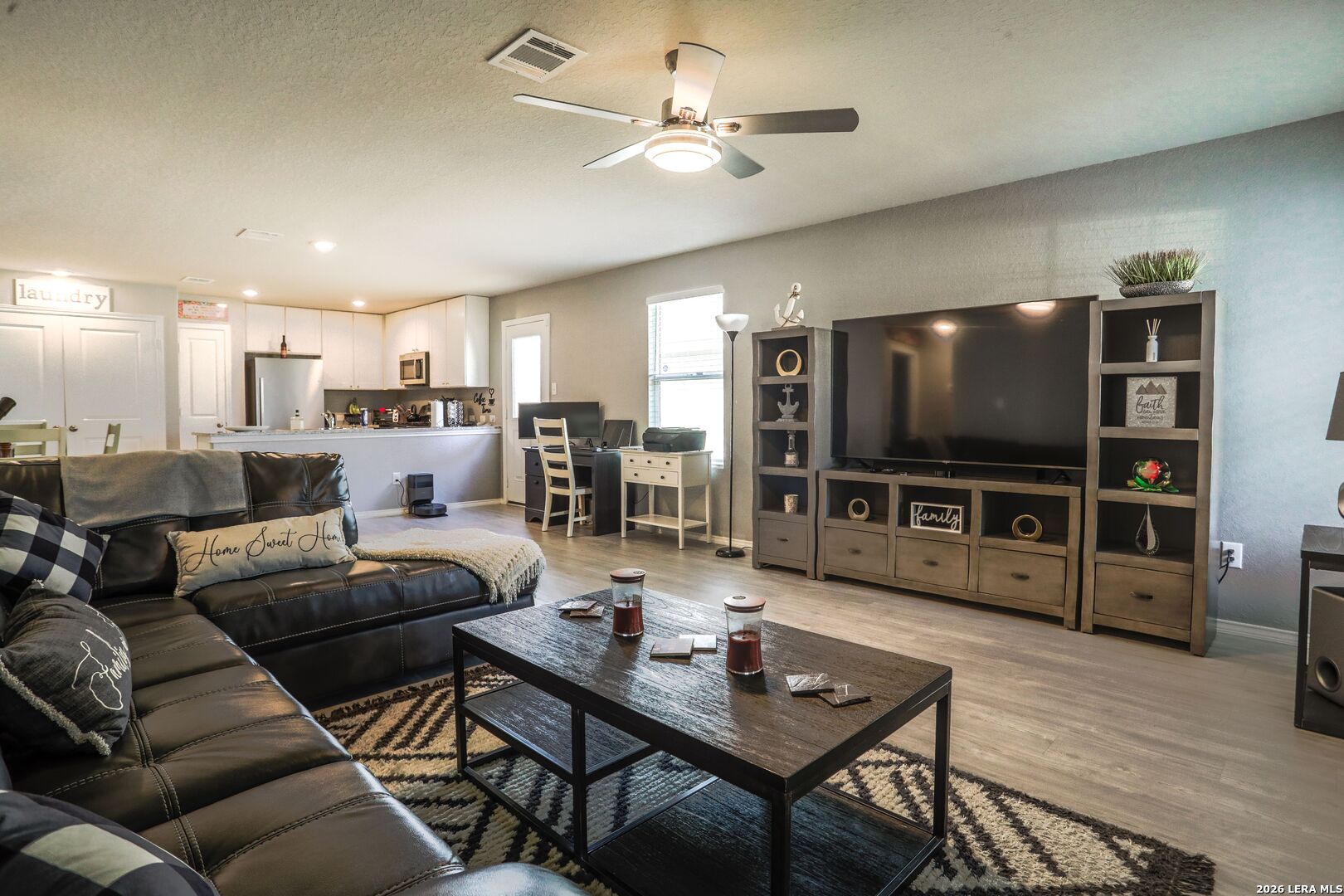 3318 Carducci Drive Converse, TX 78109 - Photo 6 of 14 a living room with furniture and a flat screen tv