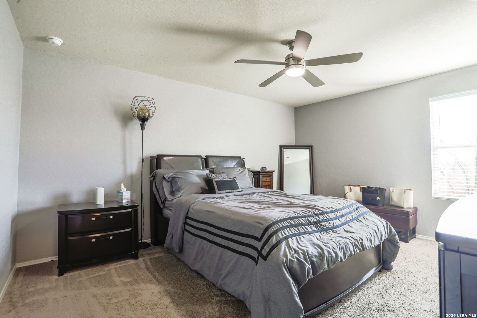 3318 Carducci Drive Converse, TX 78109 - Photo 8 of 14 a bedroom with a bed and a chandelier