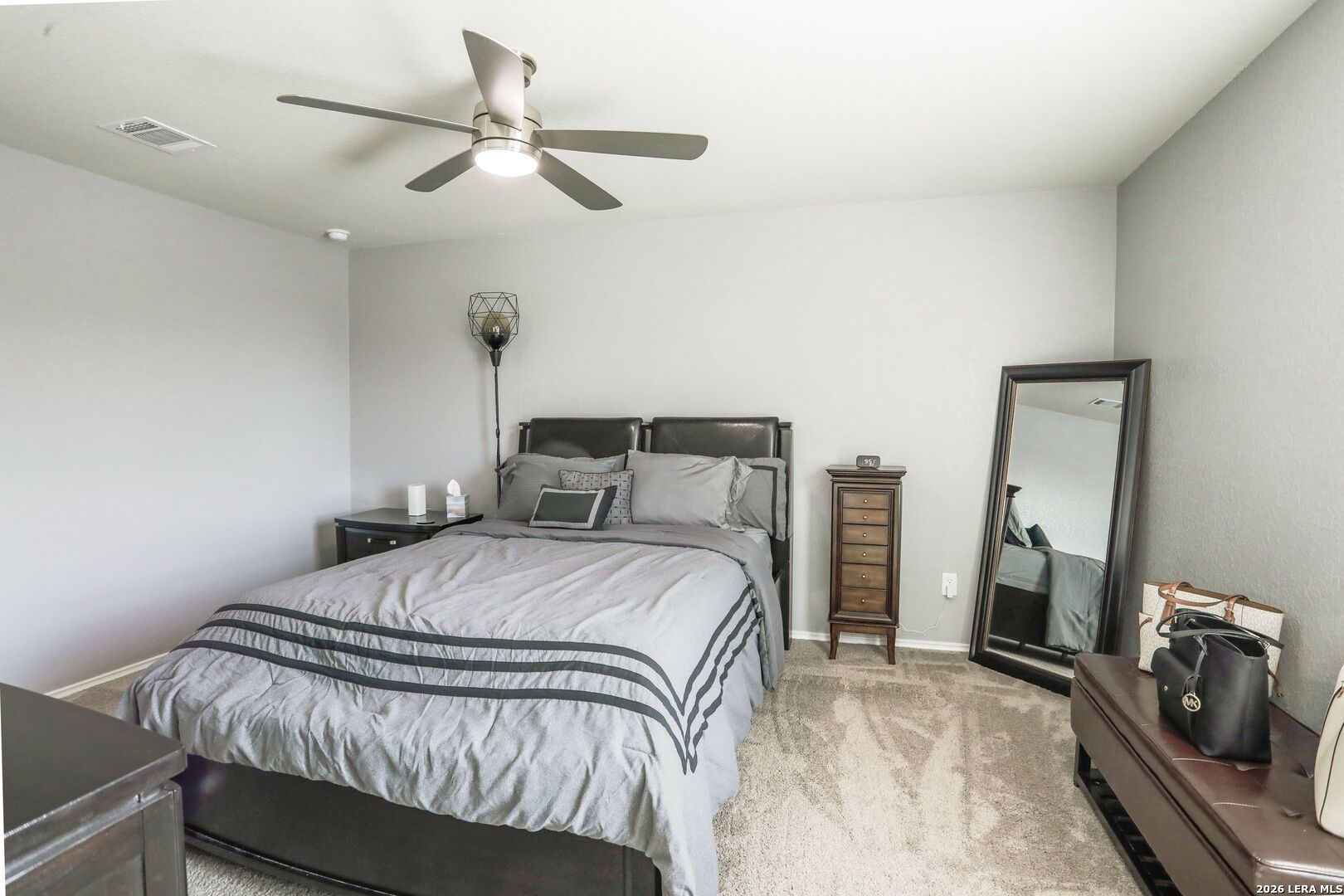 3318 Carducci Drive Converse, TX 78109 - Photo 9 of 14 a bedroom with a bed a flat screen tv and a couch