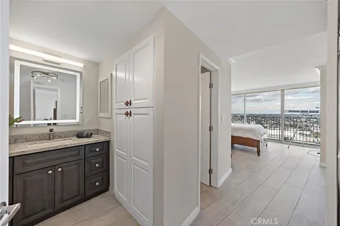 a bathroom with a granite countertop sink toilet a large mirror a vanity and shower
