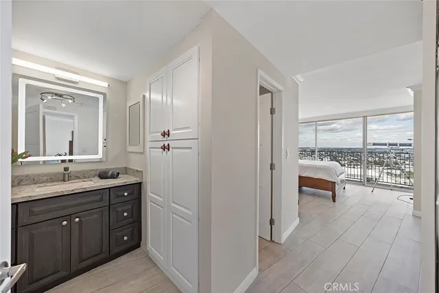 a bathroom with a granite countertop sink toilet a large mirror a vanity and shower
