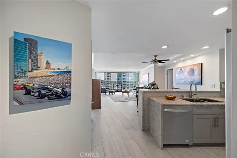 a kitchen with stainless steel appliances granite countertop a sink and a refrigerator