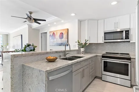 a kitchen with a refrigerator and a sink