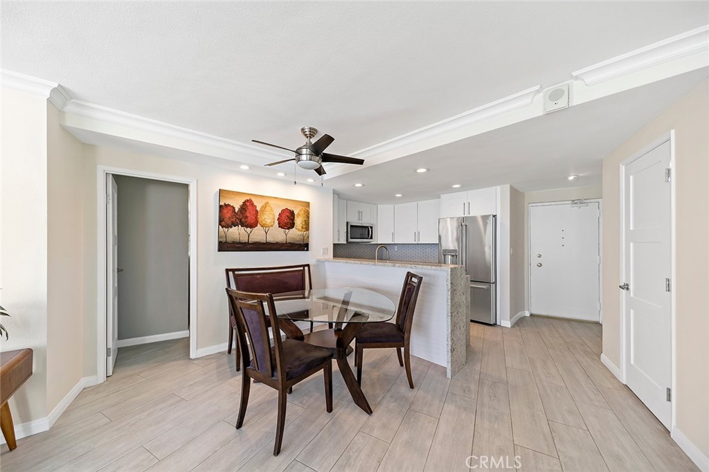 700 East Ocean Boulevard, Unit 3003 Long Beach, CA 90802 - Photo 10 of 39 a view of a dining room with furniture and wooden floor