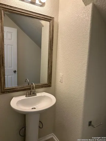 a bathroom with a sink and mirror