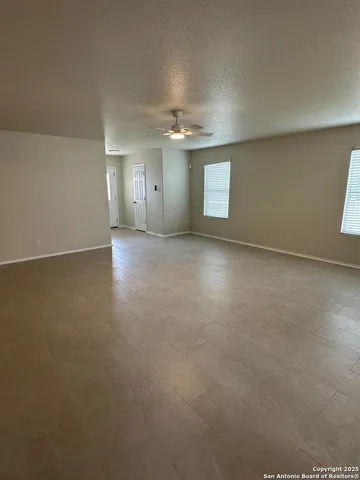 an empty room with a empty space and windows