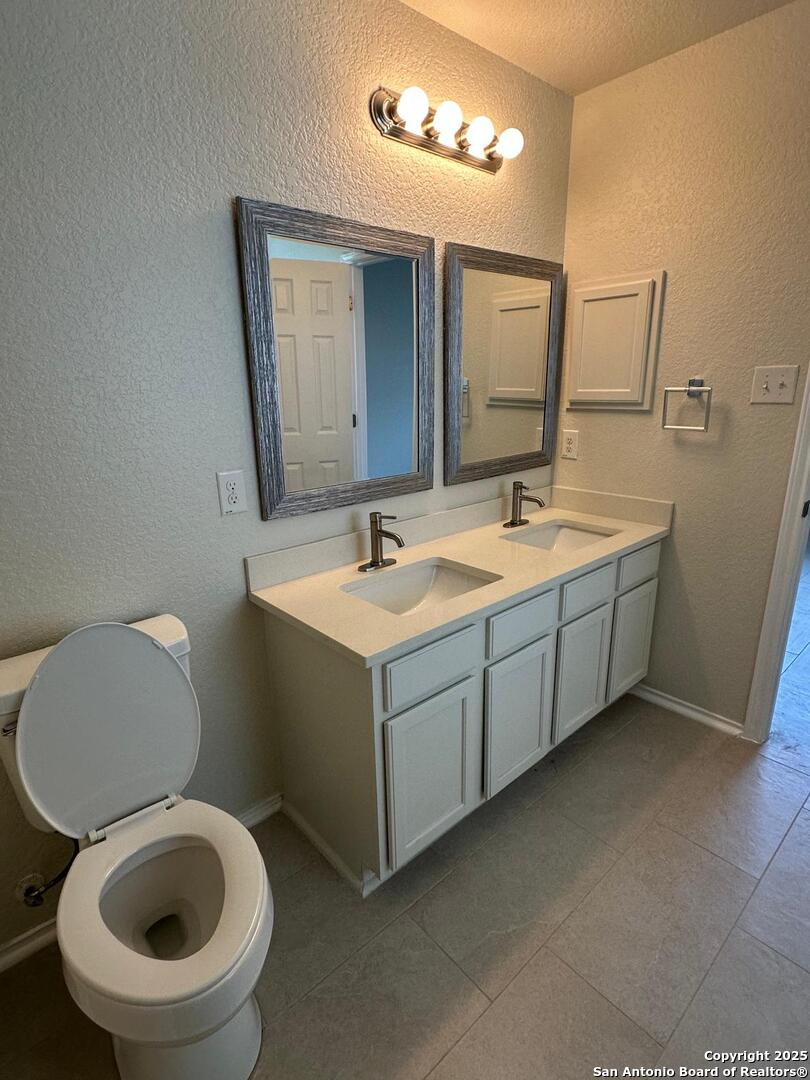 25346 Colt River San Antonio, TX 78261 - Photo 16 of 35 a bathroom with a toilet sink and mirror