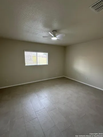 an empty room with a empty space and windows