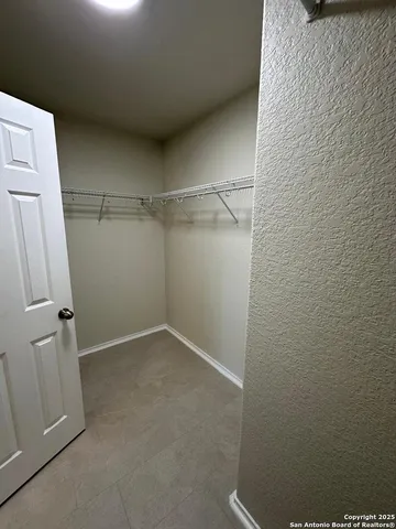 a view of a living room and kitchen with furniture and a window