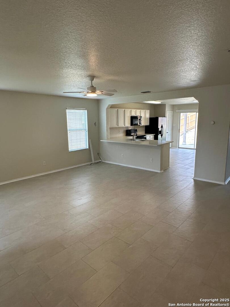 25346 Colt River San Antonio, TX 78261 - Photo 23 of 35 a view of a living room and kitchen with furniture and a window