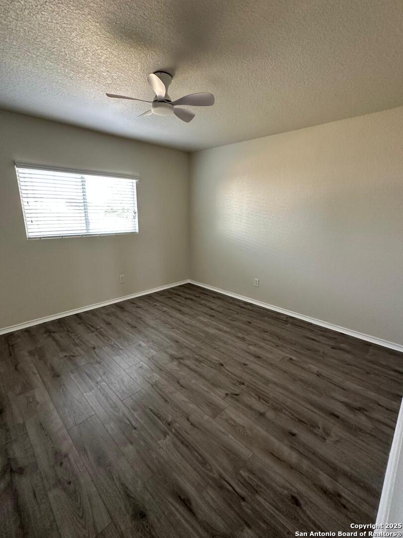 25346 Colt River San Antonio, TX 78261 - Photo 26 of 35 a view of an empty room with wooden floor and a window