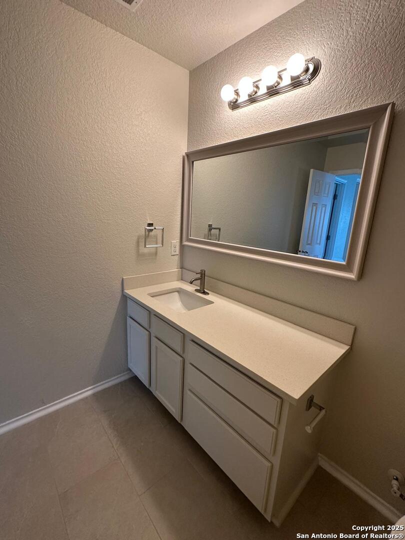25346 Colt River San Antonio, TX 78261 - Photo 28 of 35 a bathroom with a sink and mirror