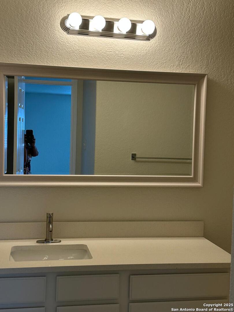 25346 Colt River San Antonio, TX 78261 - Photo 30 of 35 a bathroom with a sink and mirror