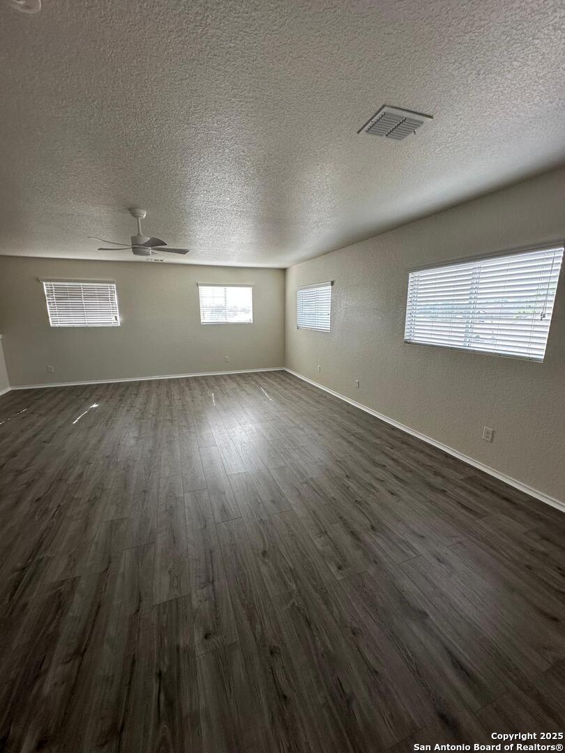 25346 Colt River San Antonio, TX 78261 - Photo 32 of 35 an empty room with wooden floor and windows
