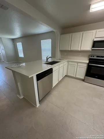a kitchen with a sink stove and cabinets