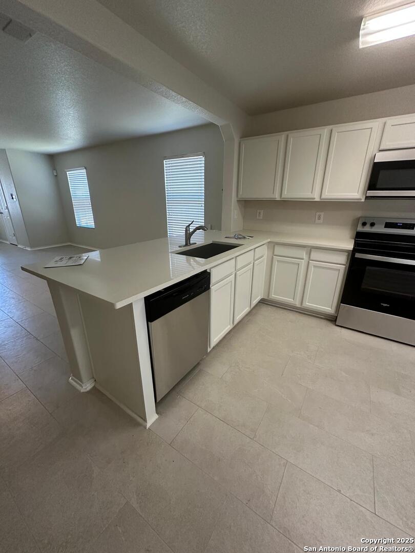 25346 Colt River San Antonio, TX 78261 - Photo 5 of 35 a kitchen with a sink stove and cabinets