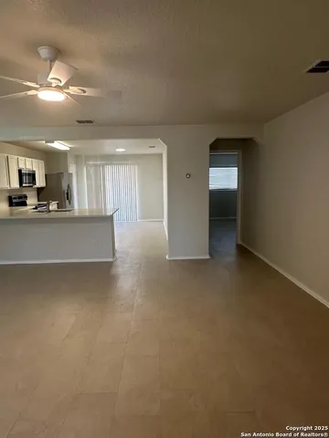 a view of a livingroom and kitchen space with a sink