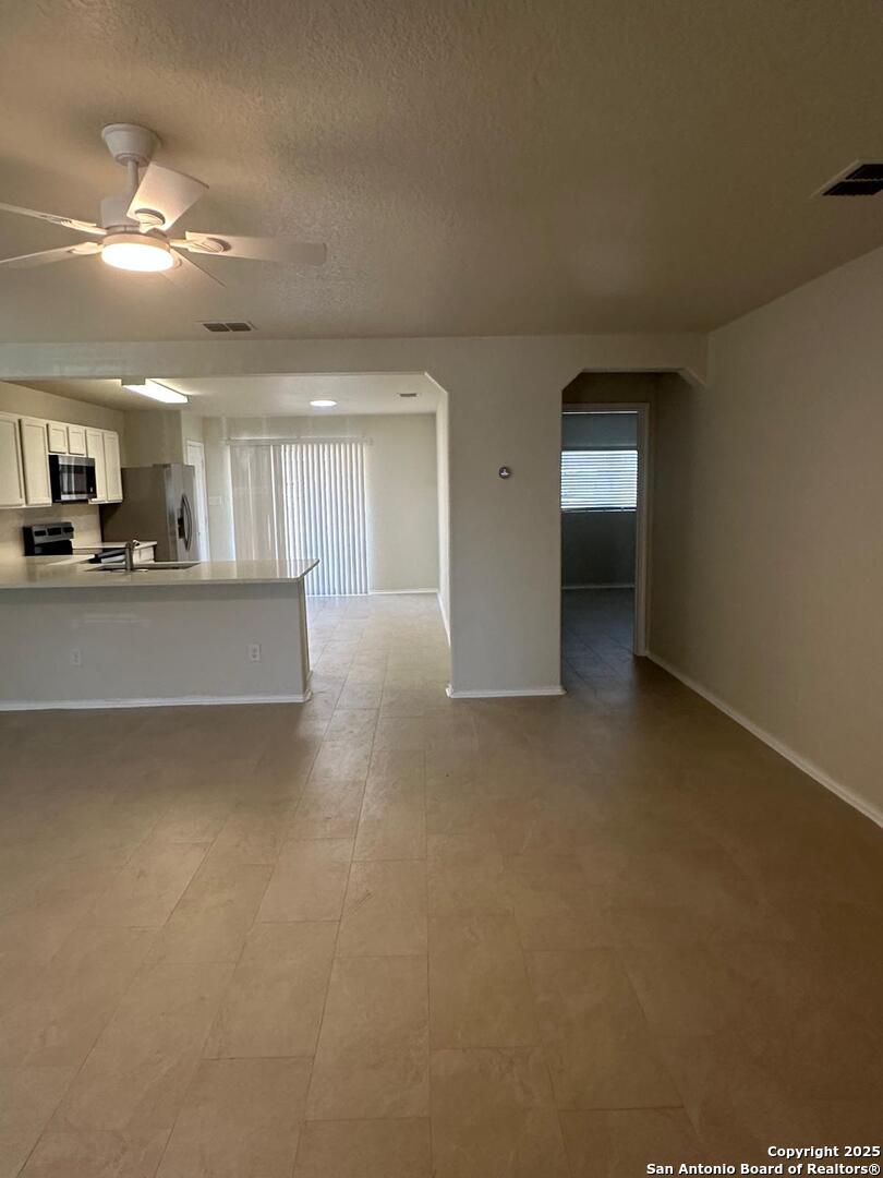25346 Colt River San Antonio, TX 78261 - Photo 9 of 35 a view of a livingroom and kitchen space with a sink